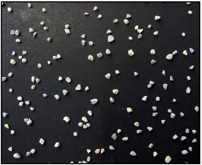 Agricultural limestone particles ground to pass a 10-mesh sieve and retained on a 20-mesh sieve