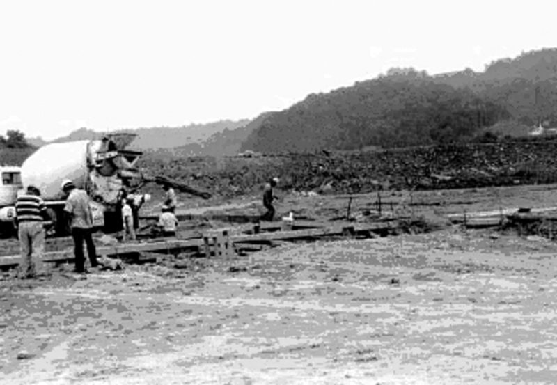 Pouring footings at the Red Onion Prison site after site stabilization. The surcharge fill is visible in the background of the photo.
