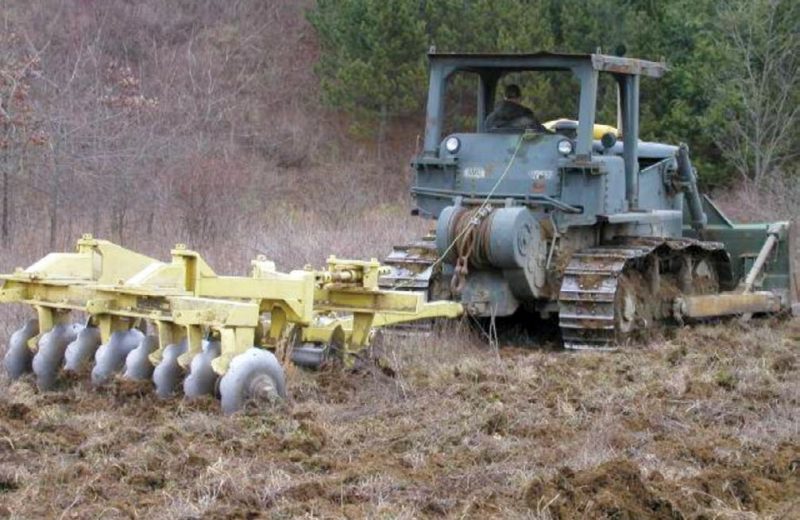 Figure 8. A large disk being used to break up surface soil and herbaceous vegetation root mass prior to soil ripping. This operation is not always necessary, but it can increase the efficiency of the deep tillage operation on sites where dense vegetation is present.