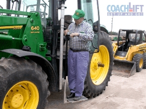 Person on platform tractor lift