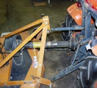 A power take off shaft is used to attached a mover, pulled behind the tractor, to the center of the rear axel of the tractor.