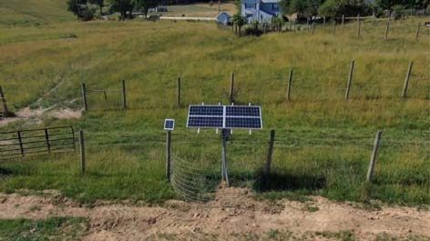A solar water pumping system installed in a field.