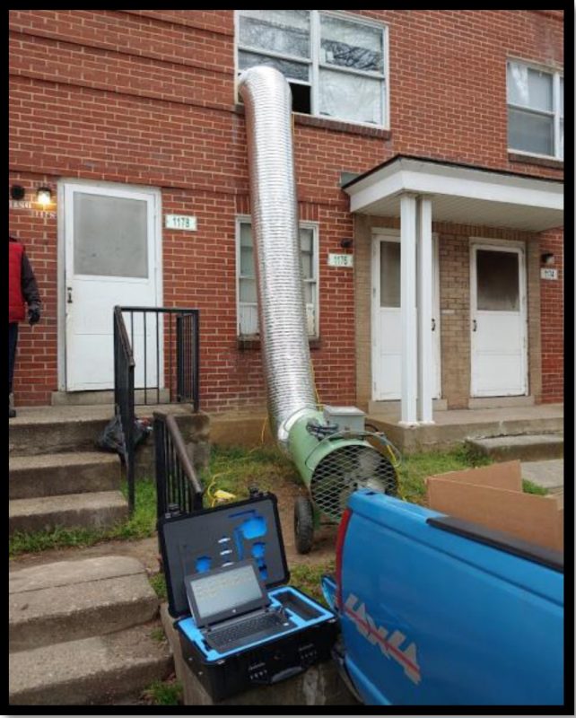 GreenTech propane heater with mylar tubing directing the heat into an upstairs apartment window.