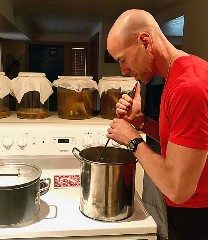 a photo of a person stirring tea on the stove