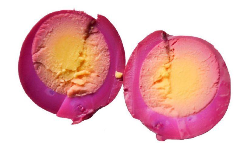 Photo of pickled beet egg, sliced in half.