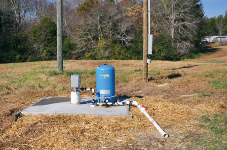 a photo of a well with a concrete pad