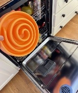 A dishwasher with a bowl of food in it