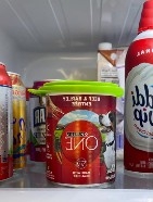 A picture containing a overed bottle holding pet food.