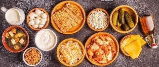 10 bowls fermented foods on a dark table