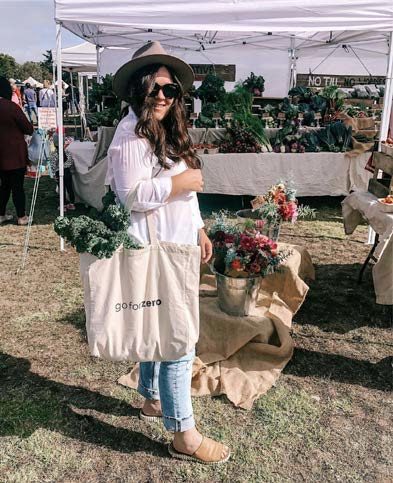 Figure 1. A person holding a reusable bag at the farmer’s market (Florida Farmers Market).