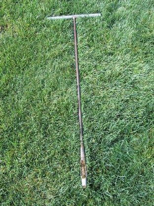 A soil probe has collected a four inch depth sample for testing.