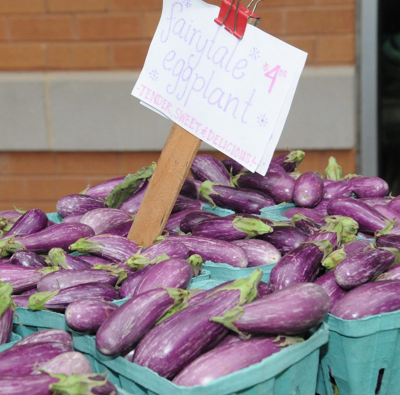 Light purple eggplant in green cartons.